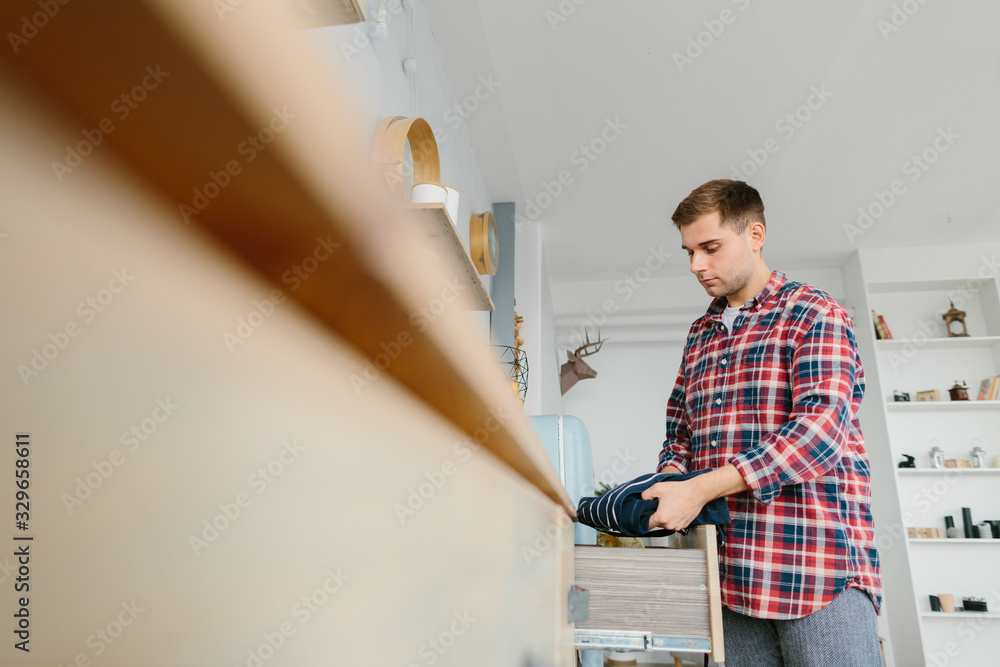 Young man cleans in the kitchen Young man cleans in the kitchen