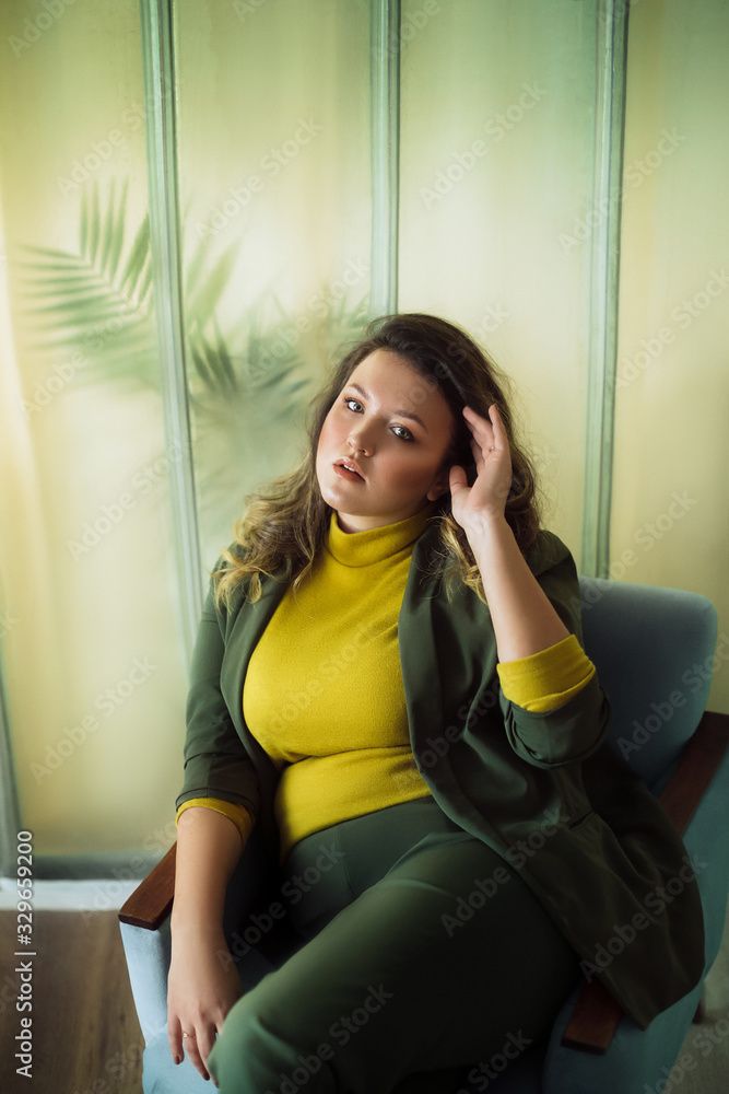 Portrait of beautiful young woman with makeup in fashion green clothes Portrait of beautiful young woman with makeup in fashion green clothes