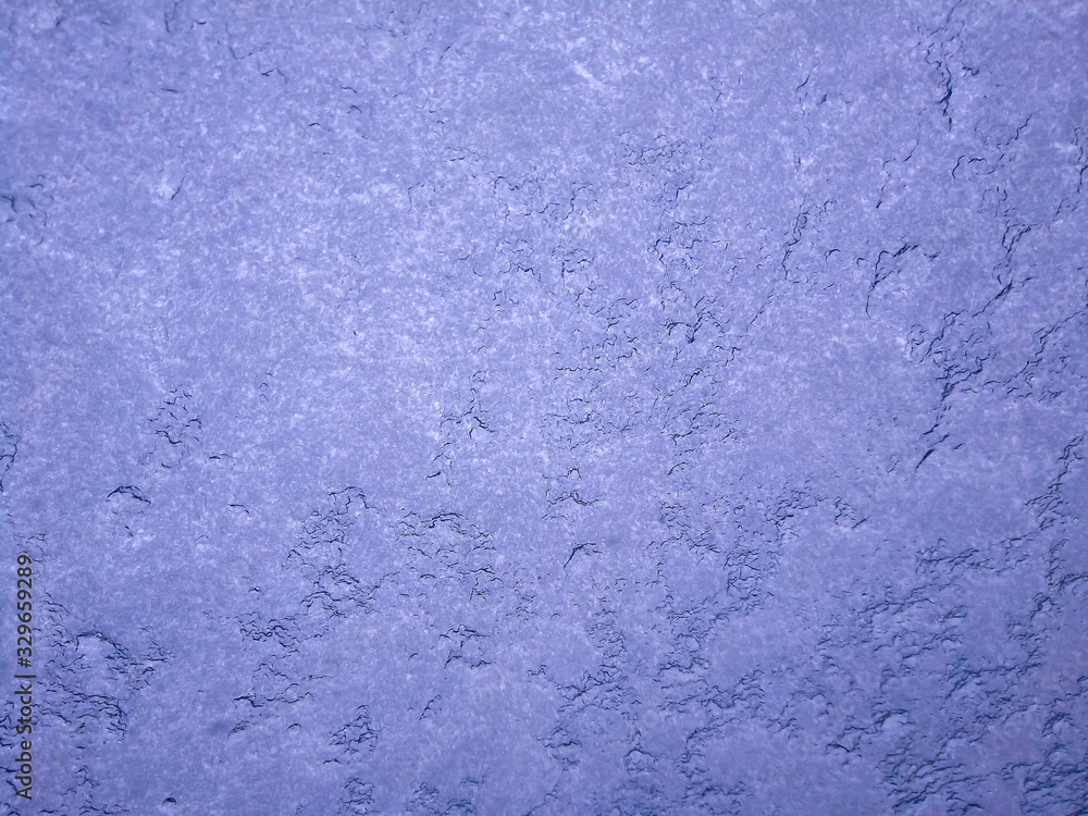 Texture of snow-white snowflakes on the surface. Beautiful frosty snow pattern on the window. Winter Wallpaper with frosty snowflakes on the glass. abstract Texture of snow-white snowflakes on the surface. Beautiful frosty snow pattern on the window. Winter Wallpaper with frosty snowflakes on the glass. abstract