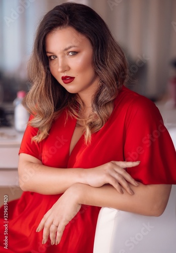 Portrait of beautiful young woman with makeup in fashion red clothes