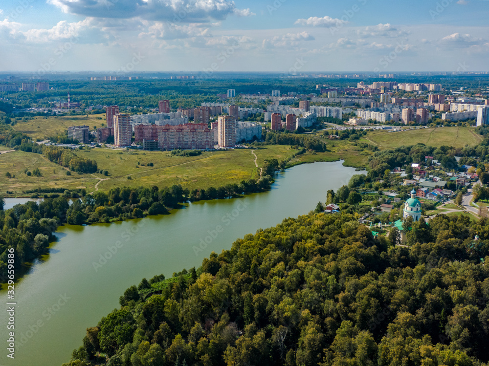 The view from above of the city of Fryazino in the suburbs, in the frame a river and forests, the Orthodox Church. Aerial photography