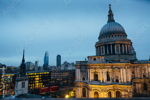 Closeup view of St. Pauls Cathedral and evening London cityscape as seen from terrace on the roof of shopping mall nearby during dusk on cloudy day