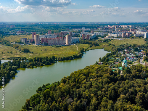 The view from above of the city of Fryazino in the suburbs, in the frame a river and forests, the Orthodox Church. Aerial photography