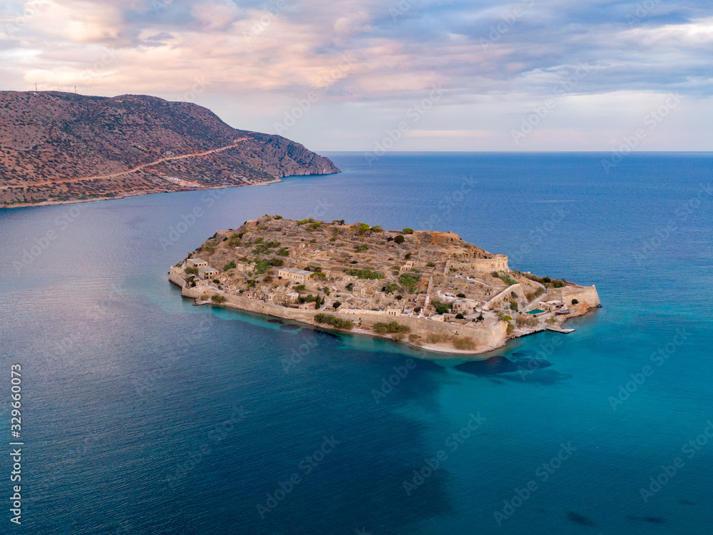 Aerial photo of Spinalonga island in blue sea waters off the coast of Crete in Greece