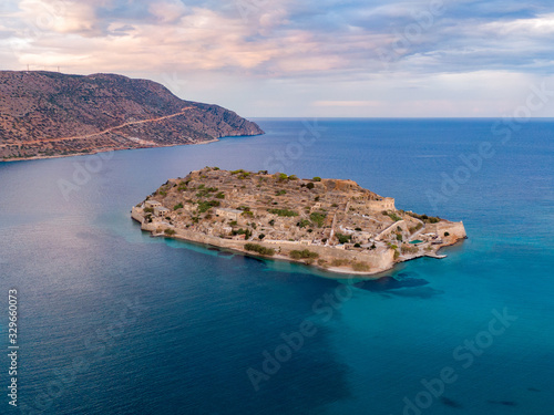 Aerial photo of Spinalonga island in blue sea waters off the coast of Crete in Greece