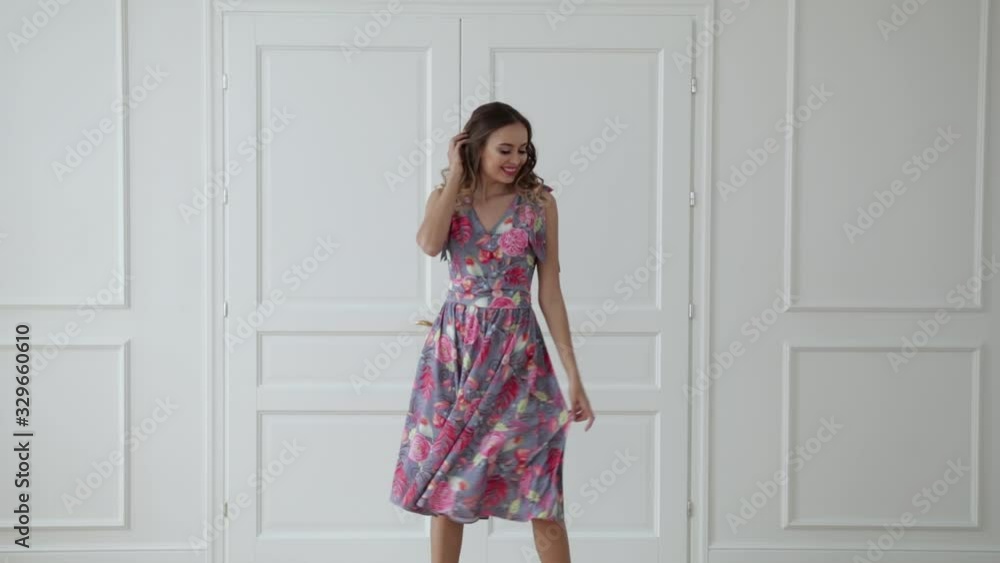 girl with brown hair, in a dress, against a background of white doors, apartment girl with brown hair, in a dress, against a background of white doors, apartment