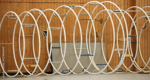 gymnastic apparatus called "Rhoenrad" (German Wheel) in a row inside of a gym
