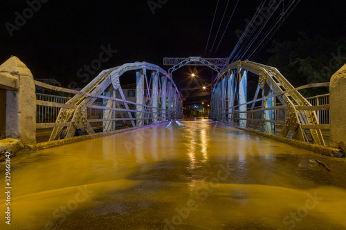 Vista noturna da ponte Raul Soares, centro da cidade de Guarani, estado de Minas Gerais, Brasil, durante enchente do Rio Pomba, em março de 2020 photo