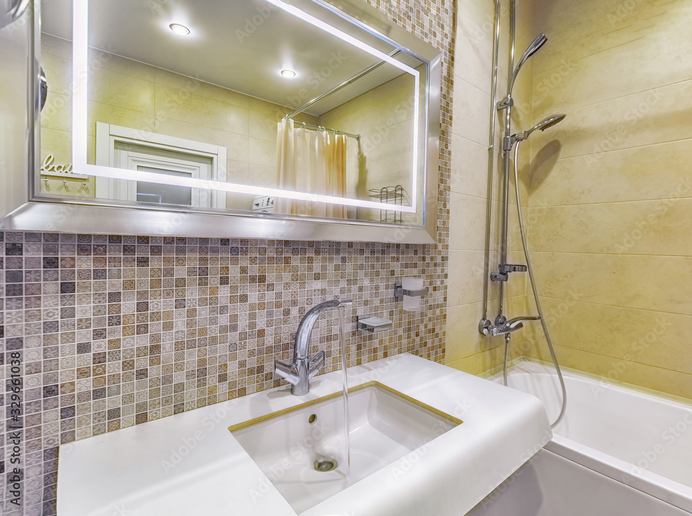 Faucet with running water in bright bathroom Faucet with running water in bright bathroom