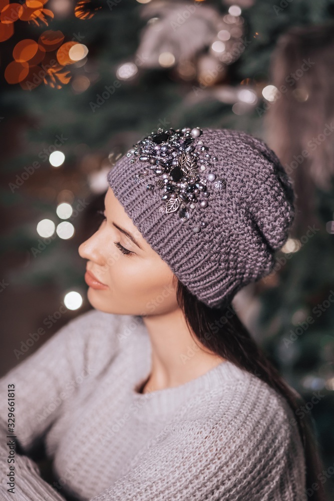 Portrait of beautiful young brunette woman with makeup in hat