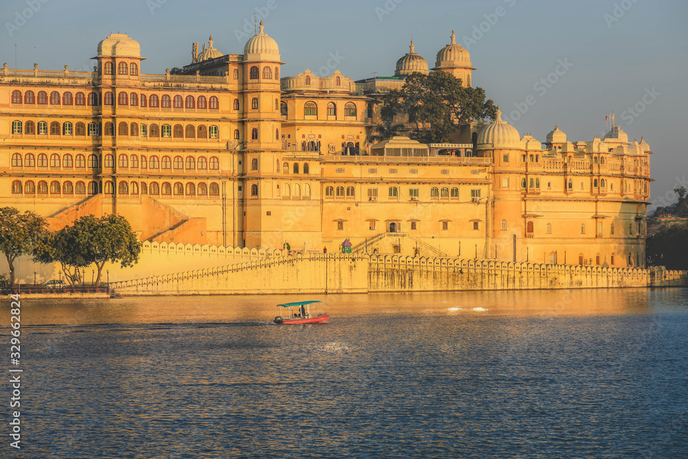 Panoramic view of the Udaipur City Palace Complex from lake Pichola in Rajasthan, India