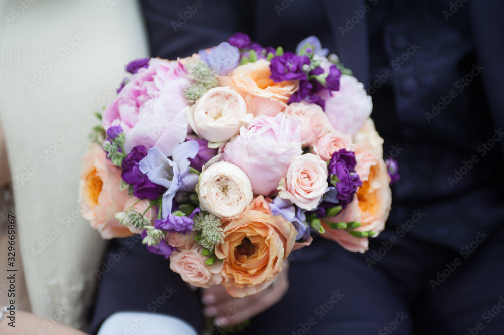 Delicate bouquet of pink and white flowers in the hands of the bride. Unusual wedding stylish bouquet with pink, orange, purple, white flowers, wedding dress, details Delicate bouquet of pink and white flowers in the hands of the bride. Unusual wedding stylish bouquet with pink, orange, purple, white flowers, wedding dress, details