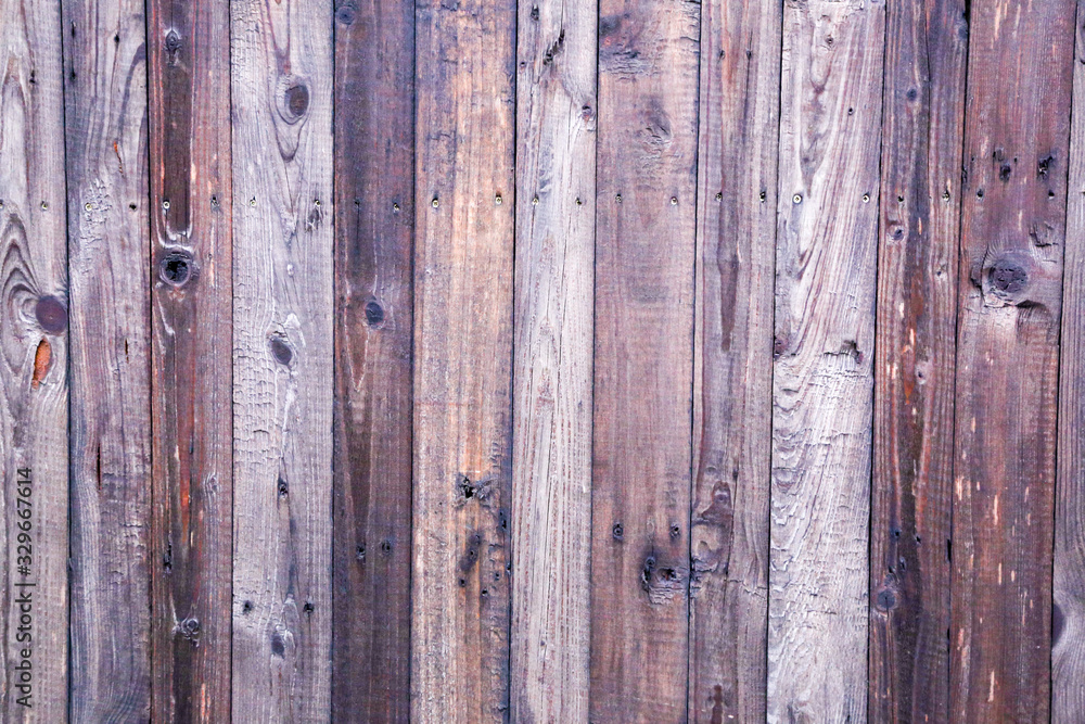 Naklejka premium Old painted wooden fence. Background texture.