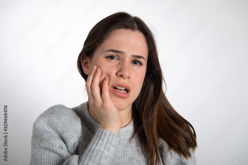 Portrait of young european woman with painfull expression. Nice long haired brunette with emotions in her face isolated on white background... Portrait of young european woman with painfull expression. Nice long haired brunette with emotions in her face isolated on white background...