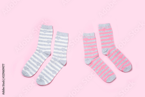 Two pairs of Women's socks on a colored background