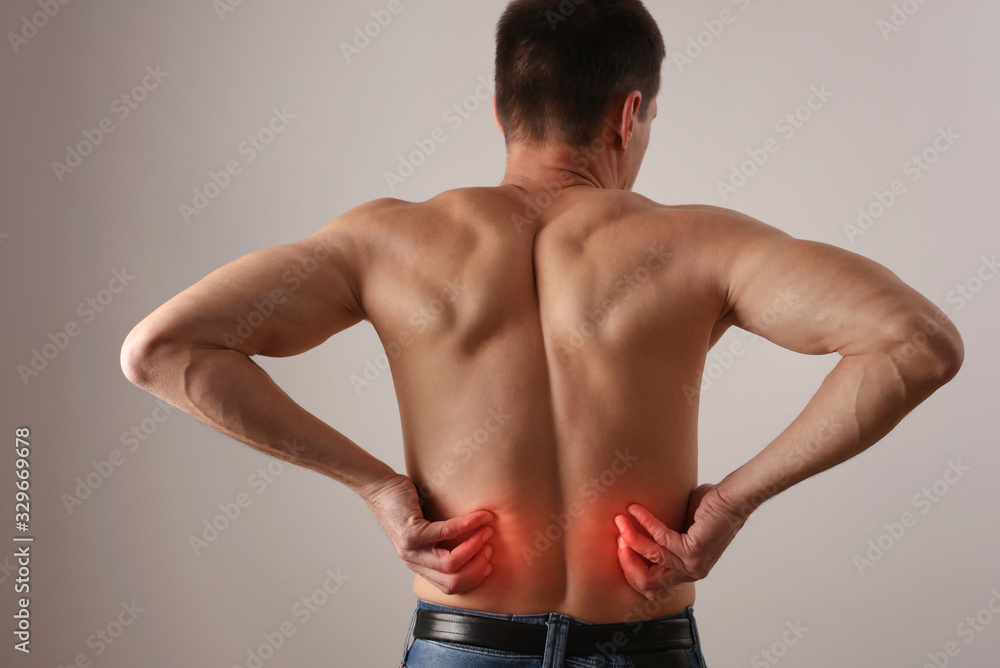 Fototapeta premium Man with low back pain. Chiropractic, Physiotherapy concept