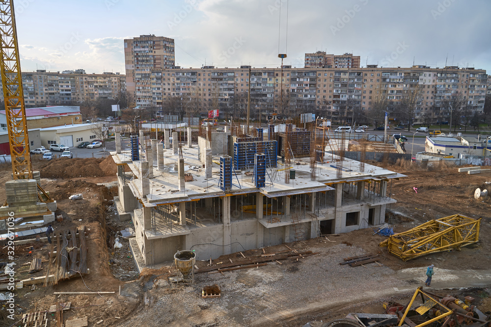 Fototapeta premium Construction site. High rise Building under construction. Construction of high-rise residential building
