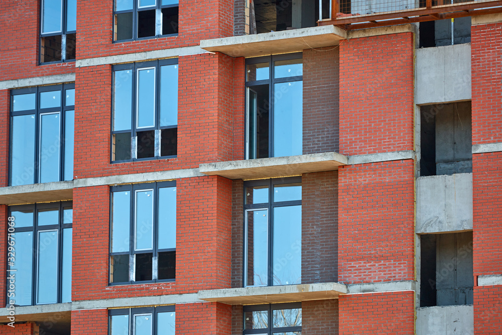 Fototapeta premium Construction site. High rise Building under construction. Construction of high-rise residential building