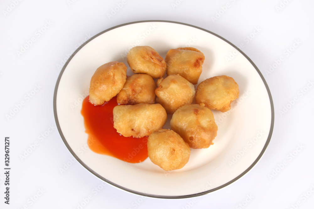 Chinese Cuisine, sweet and sour chicken balls against a white background Chinese Cuisine, sweet and sour chicken balls against a white background