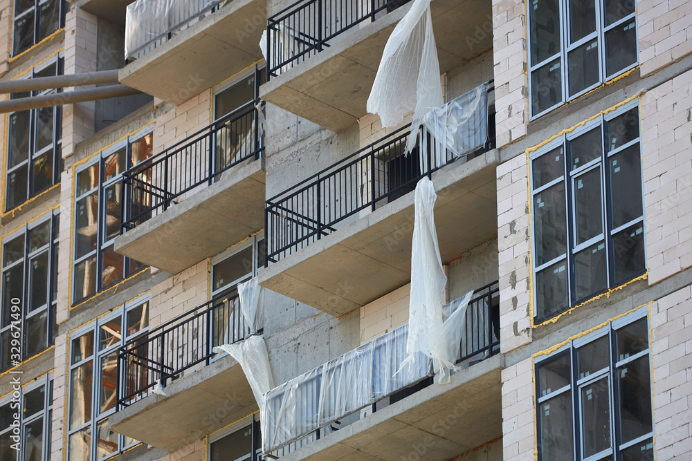 Fototapeta premium Construction site. High rise Building under construction. Construction of high-rise residential building