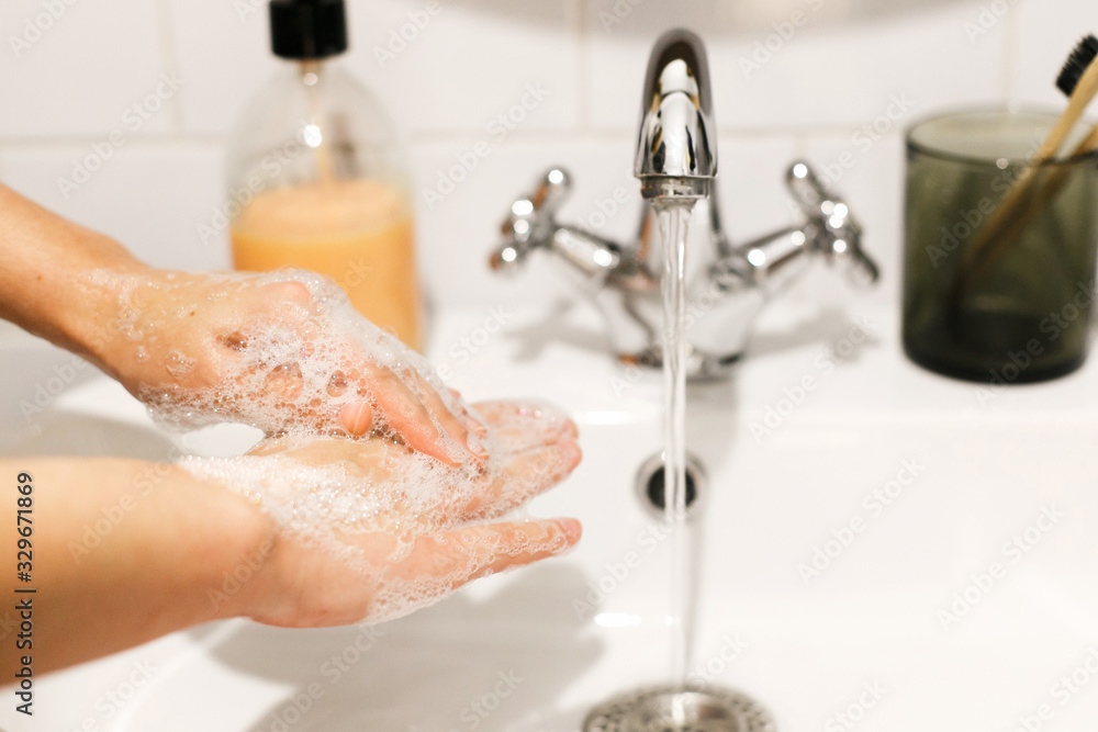 Washing hands. Hands washing with proper technique and antibacterial soap on background of flowing water in bathroom. Rubbing fingers. Prevent coronavirus epidemic. Prevention of flu disease. Washing hands. Hands washing with proper technique and antibacterial soap on background of flowing water in bathroom. Rubbing fingers. Prevent coronavirus epidemic. Prevention of flu disease.