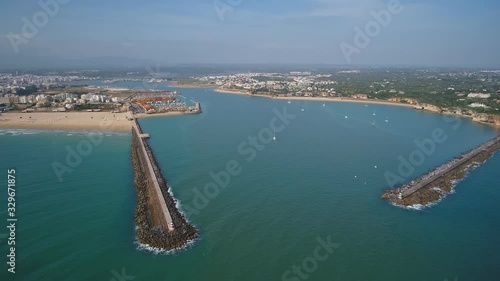 Wallpaper Mural Aerial. A pier and breakwaters at the entrance to the Arade River aerial view. Cities of Portimao. Praia de Rocha. Torontodigital.ca