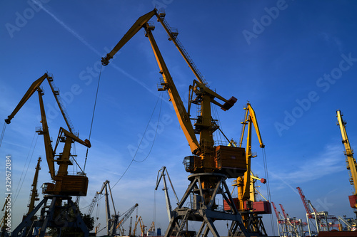 Harbor cranes in backlight. Port cranes at industrial sea port