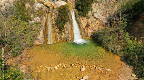 Aerial drone photo of beautiful waterfall of Valanaris in Drafi area near mount Penteli, Attica, Greece photo