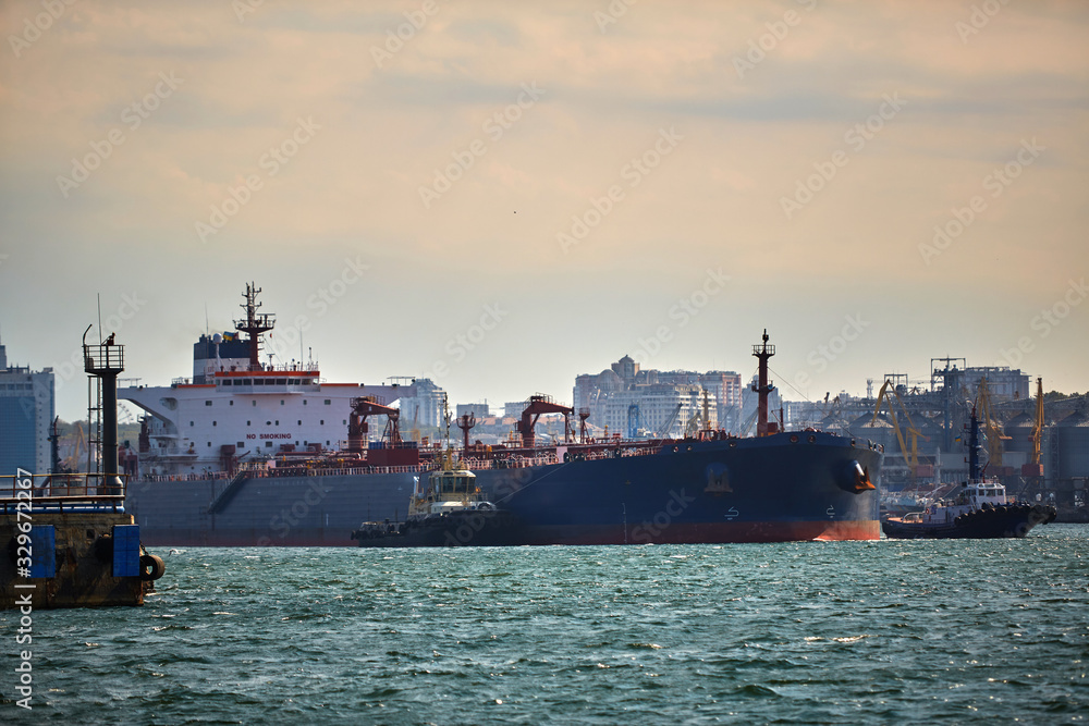 Oil tanker at the port terminal. Tanker in port at oil terminal