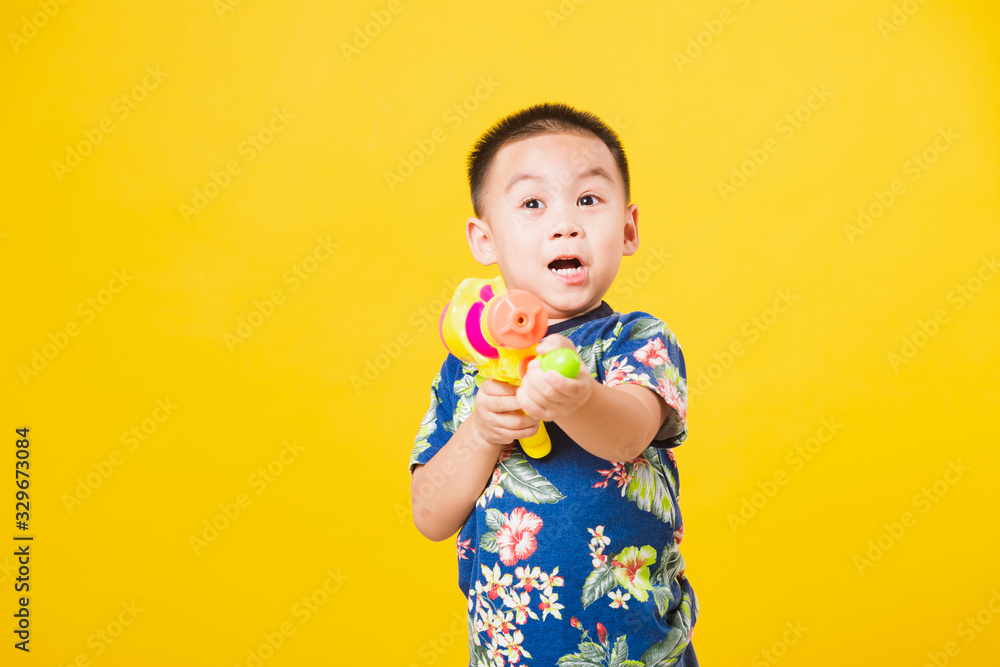 little children boy so happy in Songkran festival day holding water gun little children boy so happy in Songkran festival day holding water gun