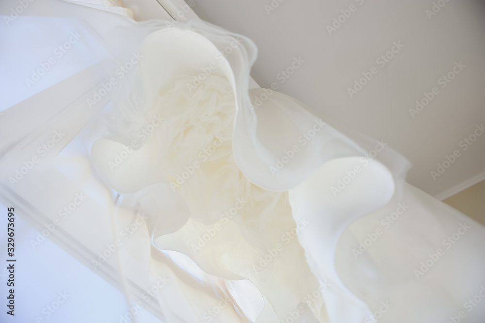 Wedding dress on a window. Happy marriage and bride at wedding day concept Wedding dress on a window. Happy marriage and bride at wedding day concept