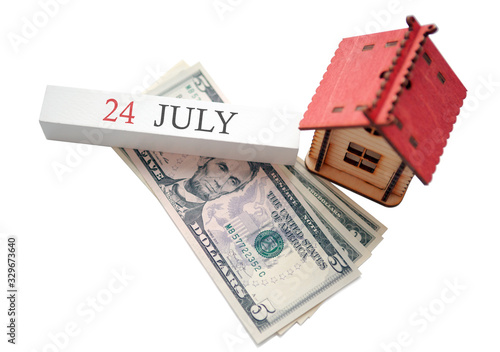 Money, home and calendar. The concept of financial independence and the scheduled start date for July 24