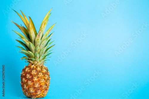Fresh ripe pineapple on a blue background
