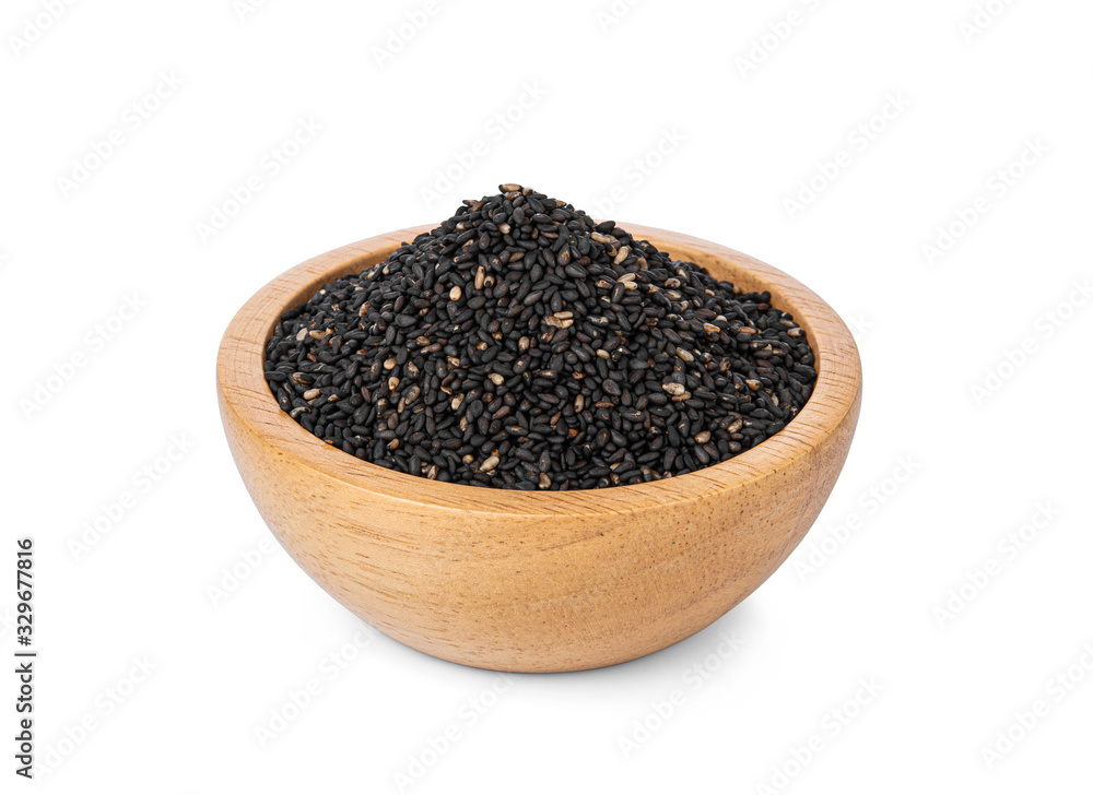 Black Sesame Seeds in a wooden cup on a white background. Black Sesame Seeds in a wooden cup on a white background.