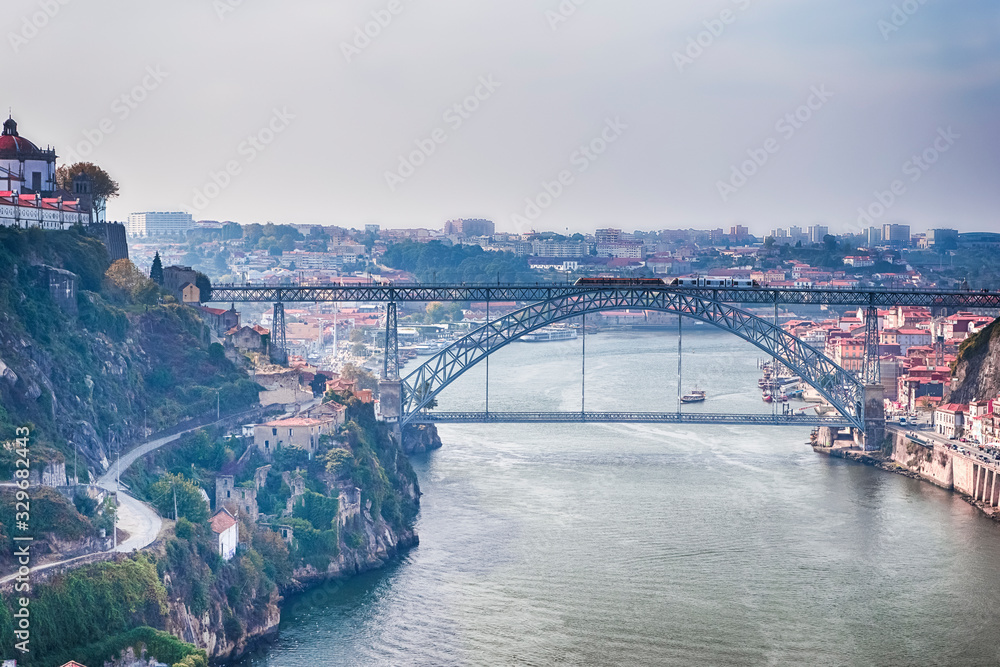 Travel Ideas. Cityscape of Porto Across The Douro River in Portugal with Red Rooftops in Background