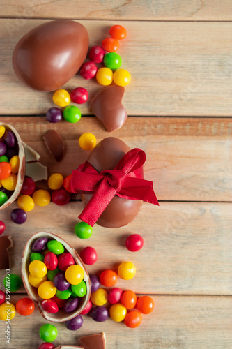 Composition of Easter sweets - chocolate eggs and candies on a brown background.