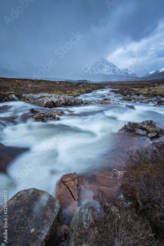 the river coupall waterfalls on rannoch moor showing buachaille etive mor in the background as the entrance to glencoe valley in winter