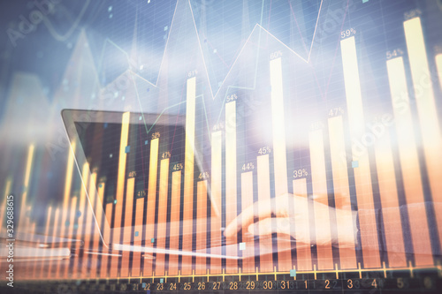 Double exposure of stock market graph with man working on laptop on background. Concept of financial analysis.