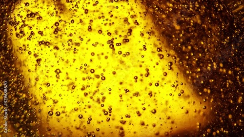 Beer bubbles. Macro footage of floating bubbles moving up. 
