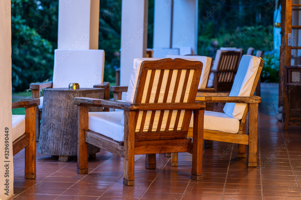 Fototapeta premium Comfortable chairs on the empty terrace in the evening, Tanzania, Africa