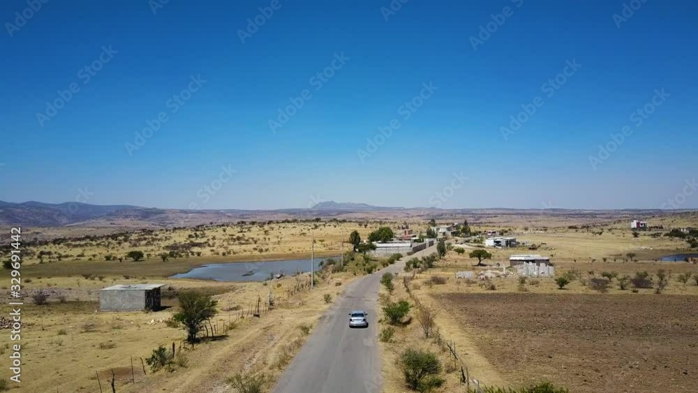 Aerial of desert outside San Miguel de Allende, Mexico - following car Aerial of desert outside San Miguel de Allende, Mexico - following car