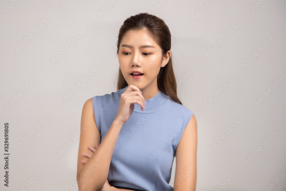 Thinking asian woman stand up isolated on white background.Asian female model smiling looking up.woman pointing fingers away on white background isolated. Thinking asian woman stand up isolated on white background.Asian female model smiling looking up.woman pointing fingers away on white background isolated.