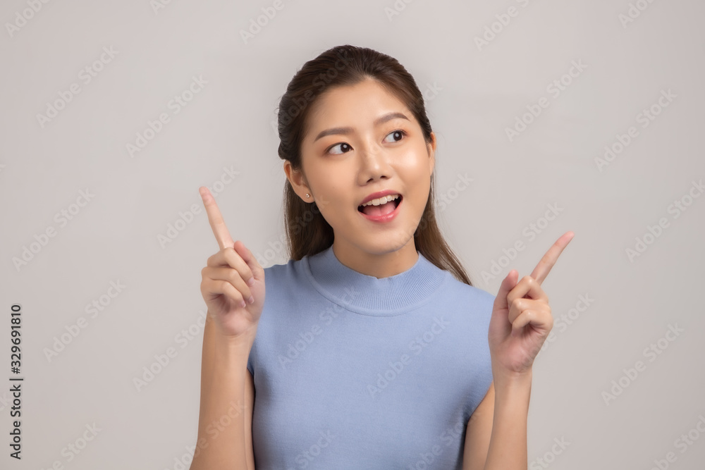 Thinking asian woman stand up isolated on white background.Asian female model smiling looking up.woman pointing fingers away on white background isolated. Thinking asian woman stand up isolated on white background.Asian female model smiling looking up.woman pointing fingers away on white background isolated.