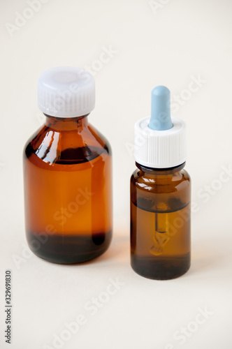 Two bottles of dark glass liquid medicine