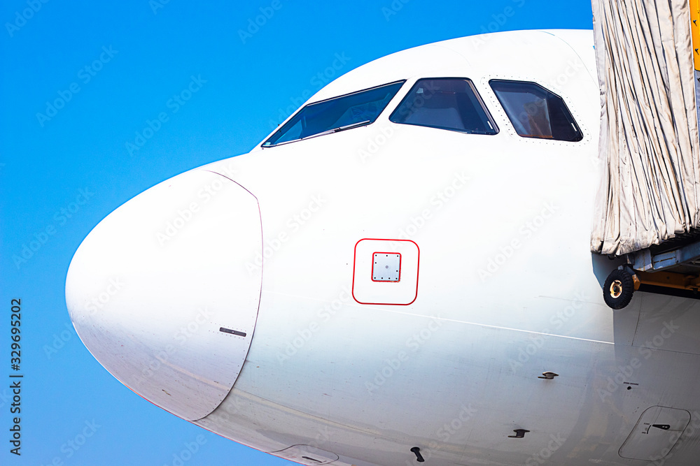 Airplane cabin behind, cockpit the door, close-up on a background of blue sky