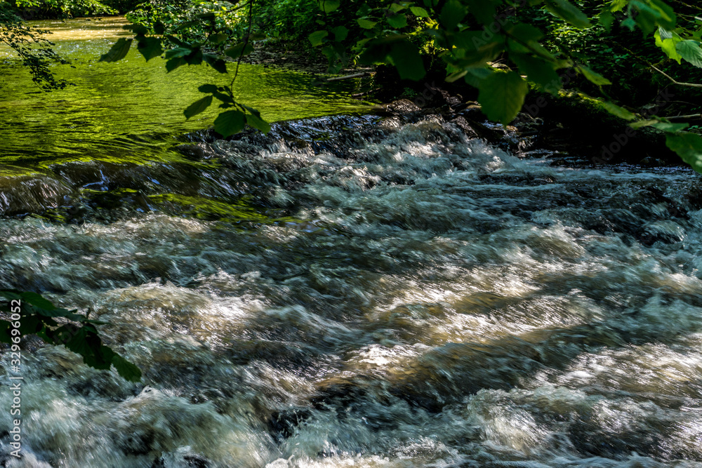 Obraz premium Germany, Moselkern Forest, a large waterfall over a body of water