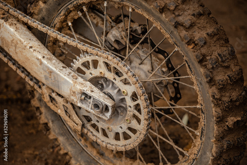 Close-up of the dirty wheel of a racing cross-country motorcycle. Lifestyle. Moto sport.