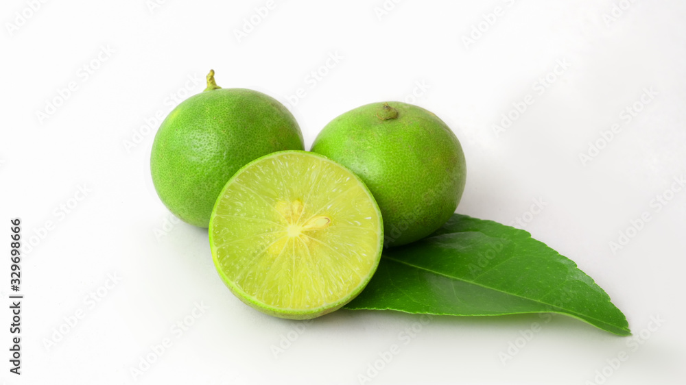 Close up view of limes and leaf isolated on white background