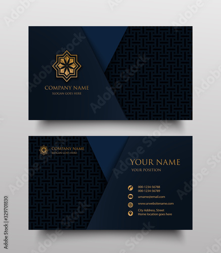 business card with gold floral ornamental logo and place for text on navy blue background