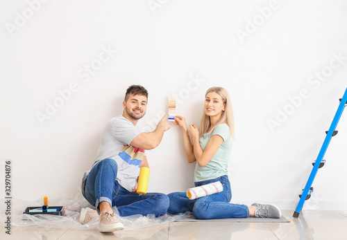 Young couple choosing color of wall